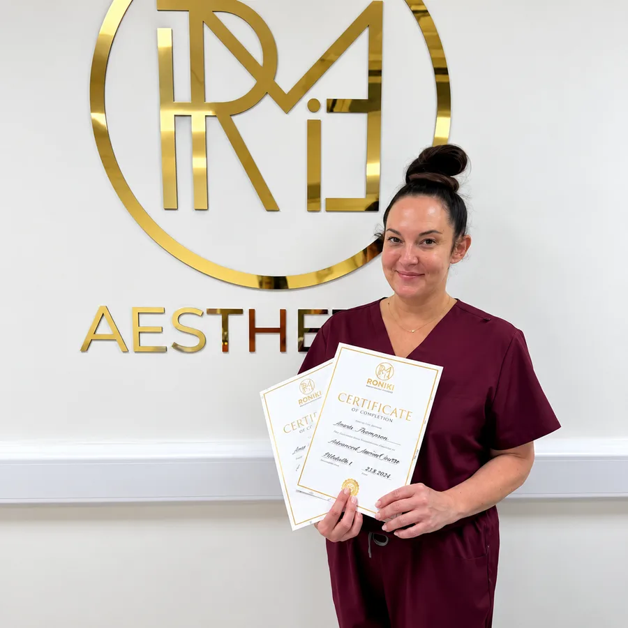 Seasons Glow practitioner holding her advanced training certificates